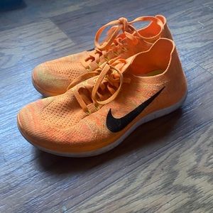 Bright orange Nike flyknits